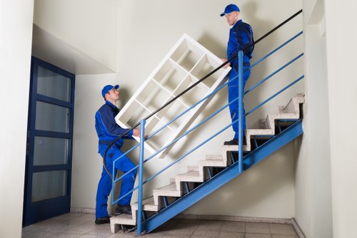 House removalists helping a Putney home move with packed boxes and furniture