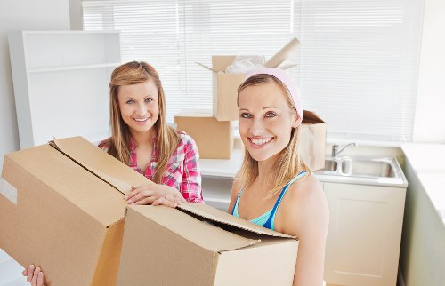 Movers handling stairs and access challenges in a Putney apartment building