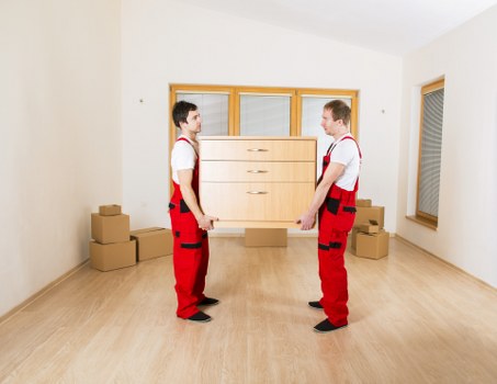 Commercial movers preparing desks and IT items for transport